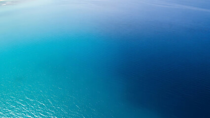 Vibrant blue ocean water with gentle ripples and sunlight reflection
