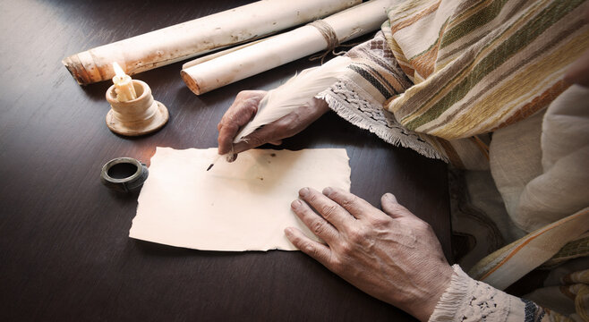 Male hand witn big quill