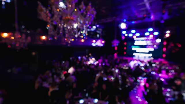 Event filled with attendees and visuals, Main hall bustling with participants and stage effects