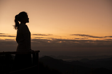 silhouette of asian woman on mountain with beautiful scene on mountain