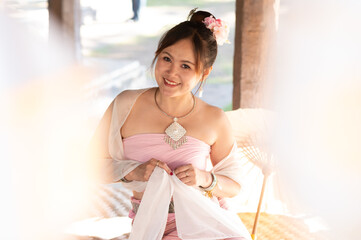 portrait of Asian woman wearing Thai northern traditional dress with foreground