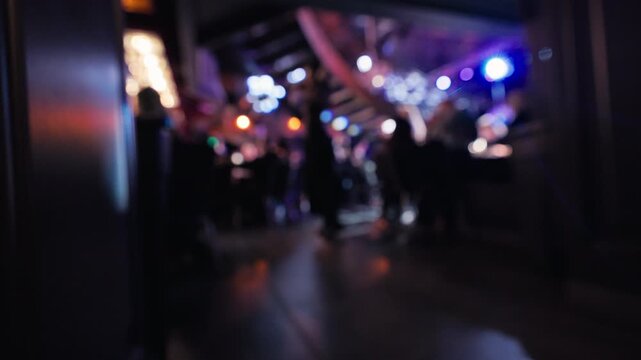 Overlooking crowded dancefloor ambiance, Mezzanine vantage reveals energetic social gatherings below