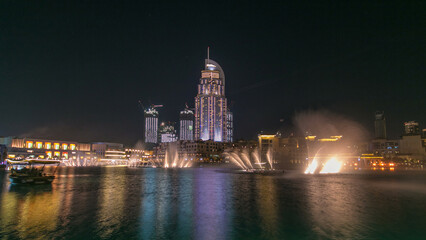 Fototapeta premium The Dancing Fountain of Dubai and lake day to night timelapse at dusk in Dubai, UAE.