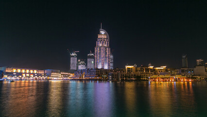 Fototapeta premium The Dancing Fountain of Dubai and lake day to night timelapse at dusk in Dubai, UAE.