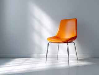 Modern bright orange chair with metal legs illuminated by soft natural light against a minimalist gray wall casting gentle shadows on a white floor