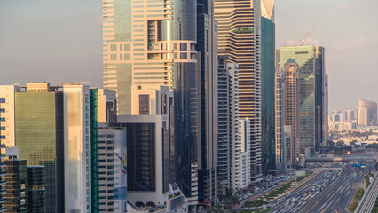 Obraz premium Downtown Dubai towers in the evening timelapse. Aerial view of Sheikh Zayed road with skyscrapers at sunset.