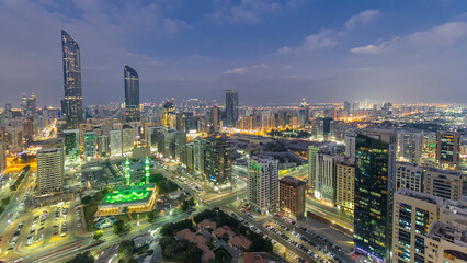 Obraz premium Modern city architecture of Abu Dhabi skyline day to night timelapse, UAE.