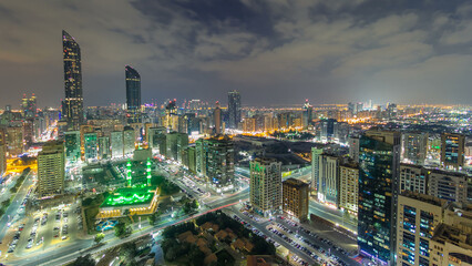 Obraz premium Modern city architecture of Abu Dhabi skyline day to night timelapse, UAE.
