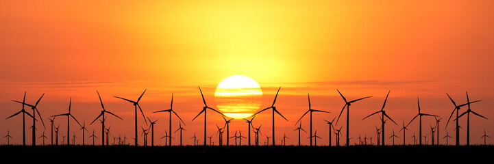 Silhouette of wind turbines against the stunning sunset and orange sky  © Stock4u2024 