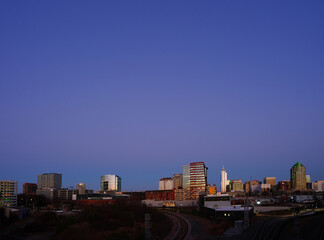 The downtown Raleigh skyline and railroad tracks looking East at sunset