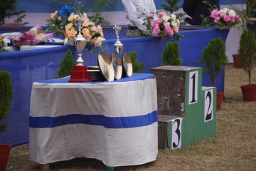 Sports award ceremony trophies flowers table