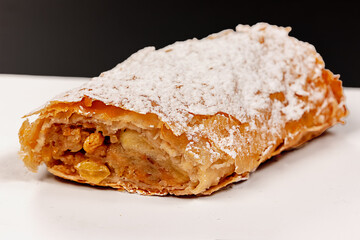 Traditional apple strudel made of layers filled with sweet apples in Central Europe during the afternoon