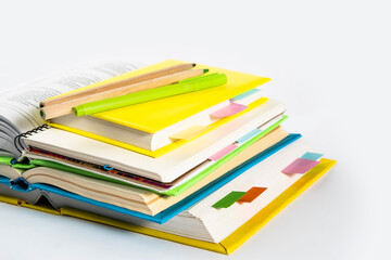 Notepad, notebooks, textbooks and books with bookmarks and stickers. The concept of diligent study