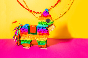 Pinata in the shape of a horse on isolated background. Rainbow-colored paper handmade Pi&ntilde;ata toy for a birthday party Mexican style.