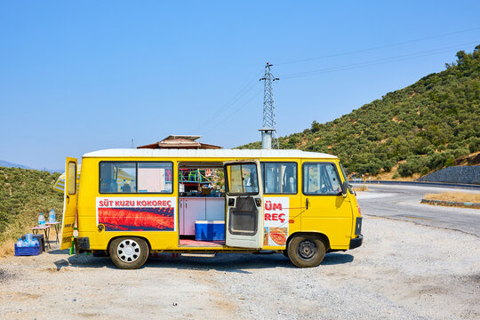 Yellow food truck offering turkish delights on rural roadside in sunny landscape. August 8, 2025 Lake Bafa Turkey