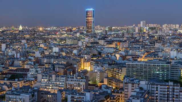 Aerial panorama above houses rooftops in a Paris day to night timelapse