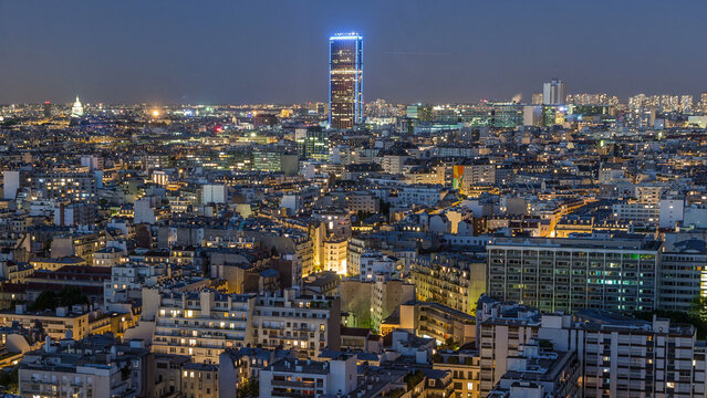 Aerial panorama above houses rooftops in a Paris day to night timelapse