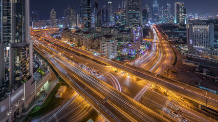 Fototapeta premium Skyline view of the buildings of Sheikh Zayed Road and DIFC day to night timelapse in Dubai, UAE.