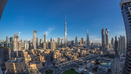 Fototapeta premium Dubai Downtown skyline night to day timelapse with Burj Khalifa and other towers panoramic view from the top in Dubai