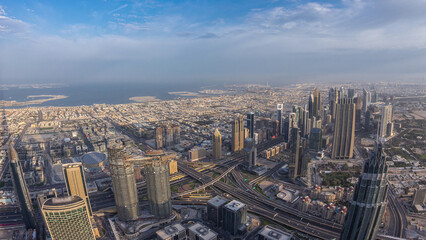 Obraz premium Downtown of Dubai night to day timelapse before sunrise. Aerial view with towers and skyscrapers