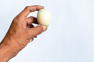 Round boiled egg in hand