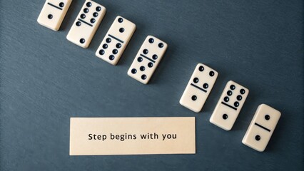 Dominoes arranged in a row with inspirational message