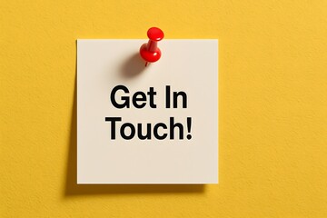 White sticky note with Get In Touch text pinned by red pushpin on yellow wall
