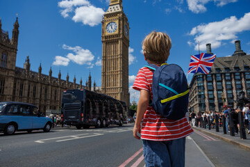 Young traveler wave UK flag by Big Ben on busy street in London