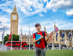 Happy student boy of English language school stand near Big Ben