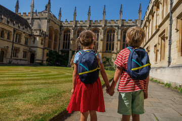 Kids explore campus of All Souls College, Oxford, Great Britain
