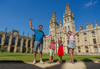 Family enjoying sunny day at historic college building in Oxford