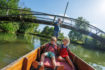 Charming boat ride under the bridge on a sunny, calm river day
