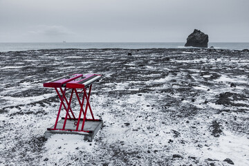 Red keyboards on volcanic beach in Reykjanes Peninsula, Iceland.