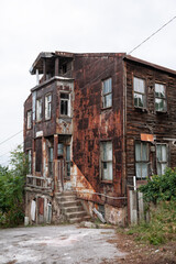 Abandoned derelict house with rustic metal wooden facade