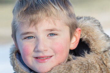 Boy with Red Rosie Cheeks Wearing a Fur Parka Outside