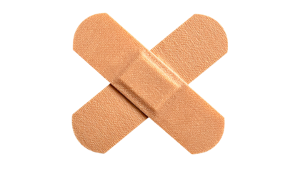 A close-up of two beige adhesive bandages, overlapping in an "X" shape, on black background