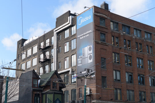 exterior of Samuel Building, 1908, at southwest corner of King St W and Spadina Av with traditional banner, Toronto