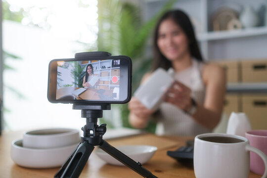 Female content creator recording video for online store.