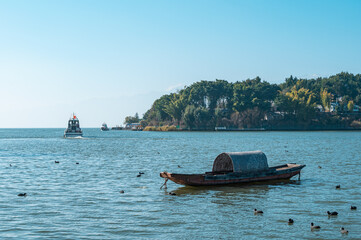 A small boat on the tranquil lake, Erhai Lake in Dali, Yunnan Province, China