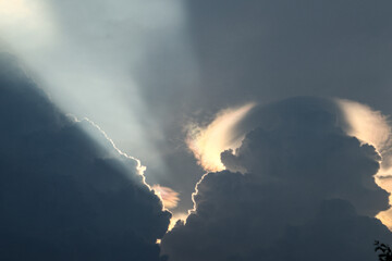 The natural phenomenon of light refraction between rain clouds occurs during the day.