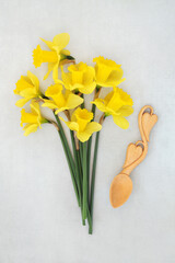 Welsh national symbols of heart shape love spoon, daffodil flowers on mottled gray background. Traditional Celtic Cymru emblems from Wales 
