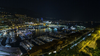 Fototapeta premium Panorama of Monte Carlo day to night timelapse from the observation deck in the village of Monaco with Port Hercules