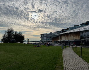 Fototapeta premium Evening sky over Tjuvholmen Sculpture Park near the Astrup Fearnley Museum in Oslo, Norway, featuring contemporary art, waterfront views, and soft twilight colors.