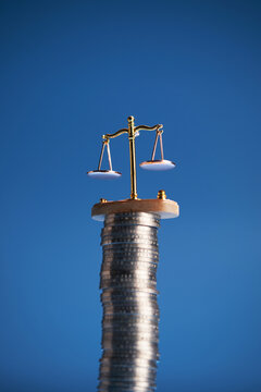 small libra scale on top stack of coins