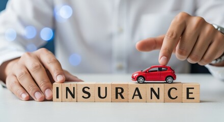 Car Insurance Conceptual: Man Protecting Toy Car with Blocks Spelling Insurance on Bright White Surface