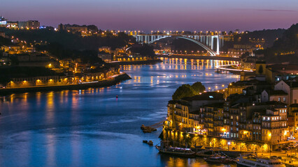 Day to night view of the historic city of Porto, Portugal timelapse from the Dom Luiz bridge