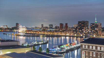 Panoramic aerial day to night timelapse of Katendrecht peninsula and Maashaven harbour in Rotterdam, The Netherlands.