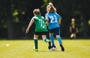 Youth Soccer Players Running With Ball &ndash; Kids Chasing Football During Outdoor Match on Green Field