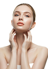 Young caucasian woman, early 20s, luminous skin, bare shoulders, nude lips, gently touching neck/jawline in a transparent studio with copy space. Concept of youthful beauty and self-care