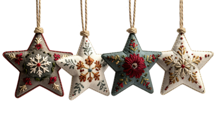 Four embroidered star ornaments hanging by twine on a dark background